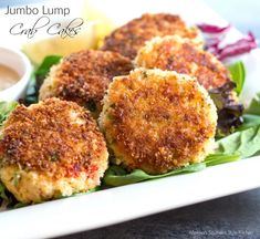 crab cakes on lettuce with dipping sauce