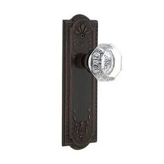 an antique style door handle with glass knob