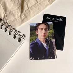 a notepad with an image of a young man on it next to a notebook