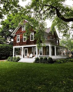 a large house sitting on top of a lush green field