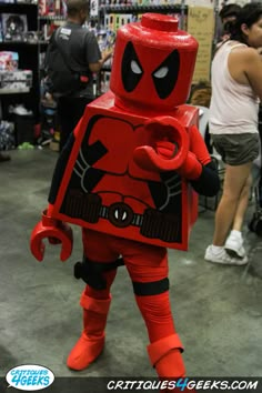 a person in a costume made to look like a deadpool character at a comic convention