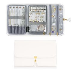 an open white purse with jewelry in it on top of a white table next to another bag