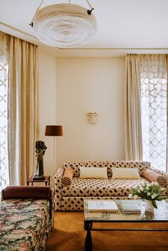 a living room filled with furniture and curtains