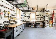 a garage filled with lots of tools and equipment on the wall next to each other