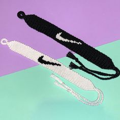 an image of a pair of scissors on a purple and blue background with white beads