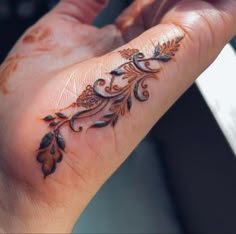 a woman's hand with a tattoo on it