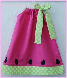 a pink and green dress with polka dots on the bottom is featured in this ad