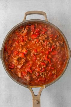 a large pot filled with chili and meat