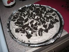 there is a pie that has been made on the stove top with chocolate chunks all over it