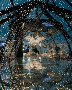 a large chandelier hanging from the ceiling in a room filled with lots of lights