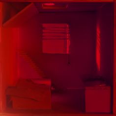 a room with red light coming from the ceiling