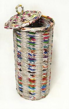 a large white basket with multicolored fabric on the bottom and lid is shown in front of a white background