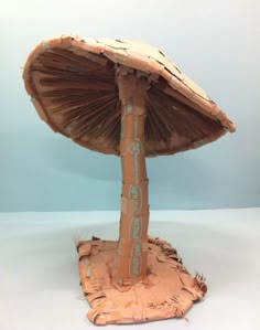 a paper mache mushroom sitting on top of a table