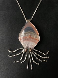 a pendant with an octopus design on it