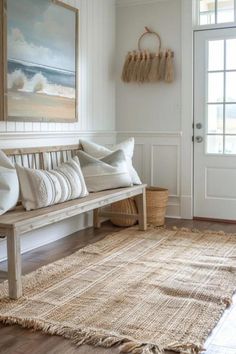 a wooden bench sitting on top of a rug in a living room next to a door