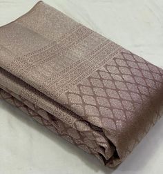 two blankets folded on top of each other with white sheets in the middle and brown pattern