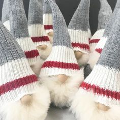 several knitted slippers with red and white stripes