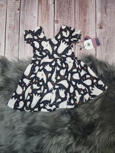 This listing is for the pictured ghost print twirl dress. The dress is soft and still includes pockets for 18m and above!   Fit:  This dress pattern hits at about or just below the knee - message me if you need a specific length or would just like a longer skirt!  The bodice is also fitted, so if you're unsure, ask for help or size up.  The back of the dress has an adorable ballet back. For a coordinating mom option, check out the mom and me add-on dress listing or message me and we'll get a custom listing set up. The bodice of this dress is made from 96% polyester, 4% spandex double brushed polyester knit.   Everything is sewn by me in my home studio in Alabama.  I use maxilock stretch to keep the seams softer and everything is serged for more secure and professional seams.  Please use th Ghost Outfit, Ghost Dress, Girls Halloween Dress, Ghost Dresses, Ghost Print, Spooky Cute, Girls Halloween, Twirl Dress, Dress For Girls