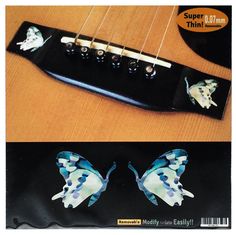 an electric guitar with butterflies painted on it