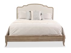 a bed with white linens and pillows on it's headboard, in front of a white background