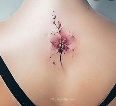 a pink flower on the back of a woman's neck