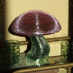 a glass lamp sitting on top of a table