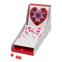 an open box with hearts and confetti inside