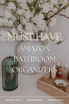 a white vase filled with flowers next to a bathroom organizer