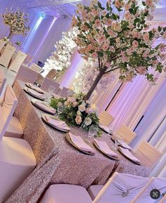 the table is set with pink and white flowers