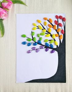 a paper tree with colorful leaves on it