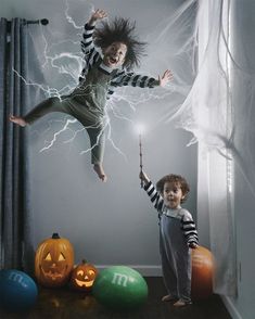 two children jumping in the air with halloween decorations