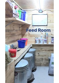 a room filled with lots of buckets next to a counter and shelves on the wall