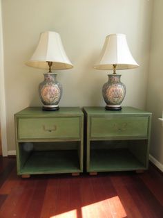 two lamps sitting on top of green nightstands