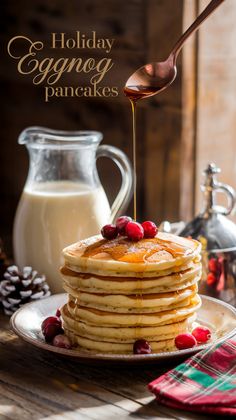 Festive holiday breakfast of eggnog pancakes with cranberries and nutmeg, syrup dripping from spoon, eggnog pitcher and plaid napkin in cozy morning light. Eggnog Pancakes Recipe, Eggnog Pancakes, Holiday Pancakes, Smoothie Bowl Healthy, Breakfast Lovers, Holiday Breakfast, Recipe Boards