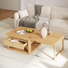 a living room with a couch, coffee table and two vases on the end tables