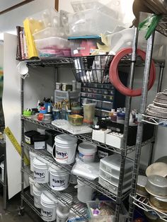 the shelves are filled with many different types of paint and other things to use for painting