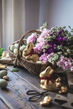 an easter basket filled with eggs and flowers