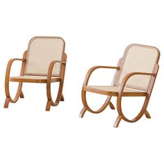 two wooden chairs sitting next to each other