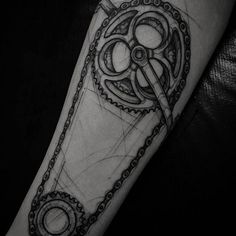 a black and white photo of a tattoo on the arm with an old style design