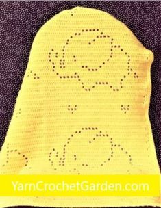 a yellow crocheted hat with the word'goggles'written on it