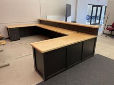 an empty cubicle with desks and chairs