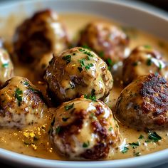 meatballs covered in gravy and garnished with parsley