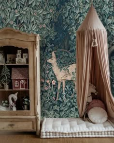 a room with a bed, dresser and wallpaper on the walls is decorated in an animal theme