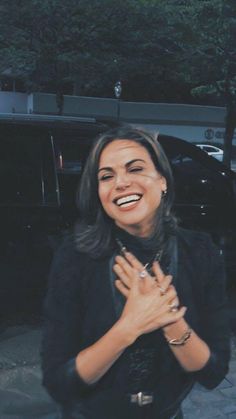 a smiling woman with her hands together