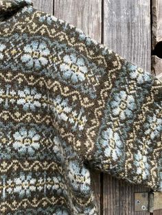 a close up of a sweater on a wooden surface