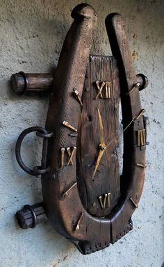 an old wooden clock with roman numerals on the side of a building wall