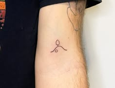 a man's arm with a tattoo on it that has an arrow and a heart