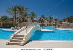 an empty swimming pool with stairs leading to it