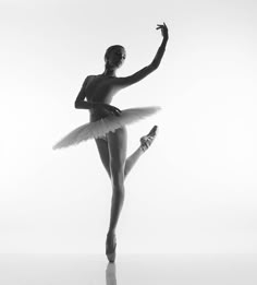 a black and white photo of a ballerina