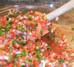 a bowl filled with chopped up vegetables on top of a table